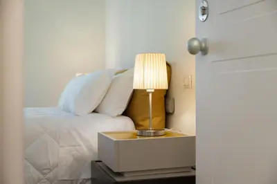 a bedroom with a bed and a table with a lamp at Mater Rooms & Suites in Rome