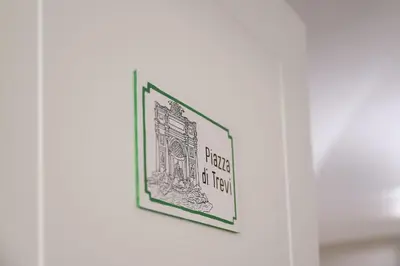 a picture of a book hanging on a wall at Mater Rooms & Suites in Rome
