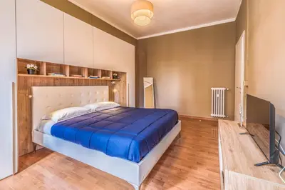a bedroom with a large bed with a blue blanket at Giuliana St.Peter Apartment in Rome