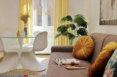 a living room with a couch and a glass table at Principe Umberto Apartment in Rome