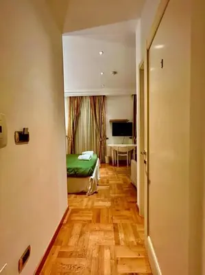 a bedroom with a bed and a desk in a room at Auditorium Maxxi luxury suite Roma in Rome
