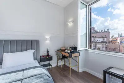 a bedroom with a bed and a window at Rome Plaza Suites, Luxury Collection in Rome