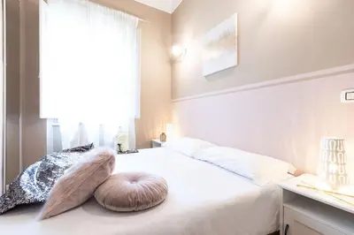 a bedroom with a large white bed with pillows on it at Colosseo Terrace Apartment in Rome