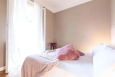 a bedroom with a bed with a blanket and a window at Colosseo Terrace Apartment in Rome