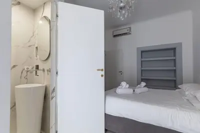 a bedroom with a bed with two stuffed animals on it at FCR Rome Apartments Gracchi Vatican in Rome
