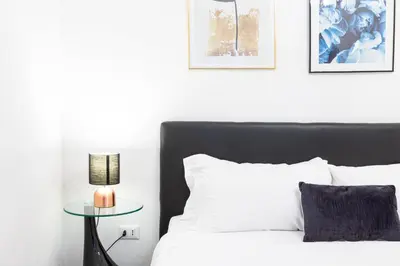 a bedroom with a bed and a table with a candle at Amazing Art Déco Apartment Pantheon in Rome
