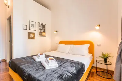 a bedroom with a bed with towels on it at Appartamento Principe Amedeo in Rome
