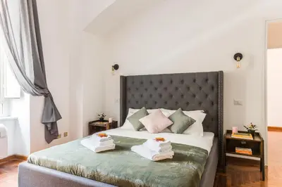 a bedroom with a bed with towels on it at Appartamento Principe Amedeo in Rome