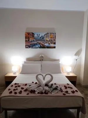 a bedroom with a bed with a heart on it at Palazzo Sant'Antonio in Rome