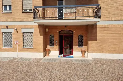 a building with a balcony and a red door at Palazzo Sant'Antonio in Rome