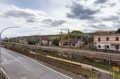 an empty street next to a road with buildings at Stylish Pigneto Apartment in Rome