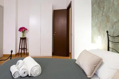 a bedroom with a bed with towels on it at Residenza Lualdi in Rome