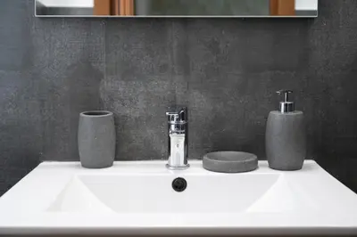 a bathroom sink with two cups and a faucet at Residenza Lualdi in Rome