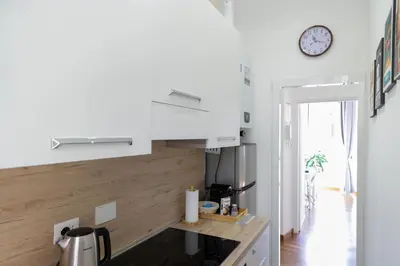 a kitchen with a counter and a clock on the wall at Pantheon Magic House in Rome