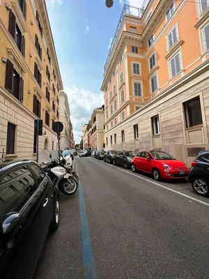 a street with cars parked on the side of the road at Dolce Vita Guest House in Rome