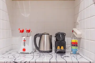 a kitchen counter with a coffee maker and a blender at Trastevere Vintage Artistic Loft in Rome