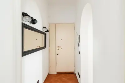 a hallway with a door and a window at R.C. Cappellari Loft Campo de' Fiori in Rome