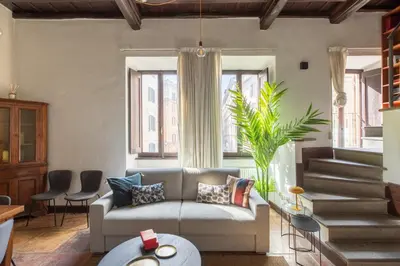 a living room with a couch and some windows at iFlat Lovely flat in Navona in Rome
