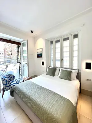 a bedroom with a bed and a table and chairs at B&B Lungotevere Flaminio in Rome