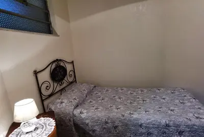 a bedroom with a bed and a table with a lamp at Appartamento per Turisti e Famiglie Roma in Rome