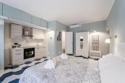 a large kitchen with a large bed in a room at The small nest at Coliseum in Rome