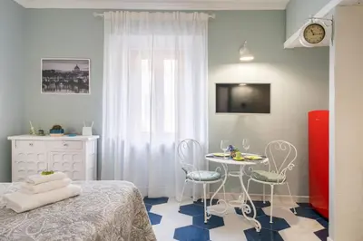 a bedroom with a table and chairs and a bed at The small nest at Coliseum in Rome