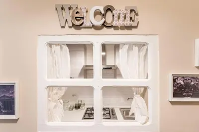a white window with a hello sign on a wall at The small nest at Coliseum in Rome
