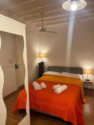 a bedroom with a bed with two towels on it at Casa Uberto in Rome