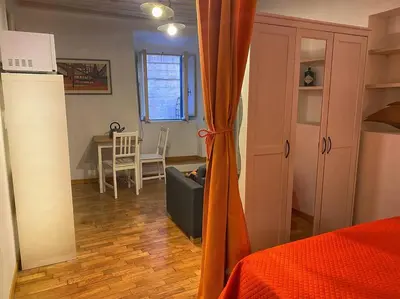 a room with a bed and a couch and a table at Casa Uberto in Rome
