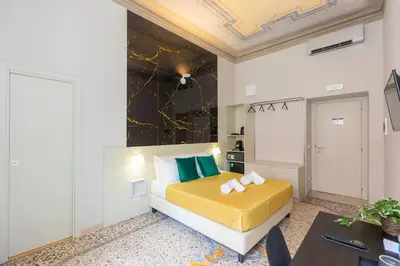 a hotel room with a bed and a table at Iron Cityaus Termini in Rome