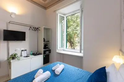 a bedroom with a blue bed with towels on it at Iron Cityaus Termini in Rome
