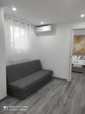 a living room with a couch and a window at Casa Mario in Rome