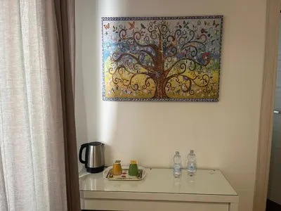 a painting hanging on a wall above a table at Anastasio Vatican Rooms G H in Rome