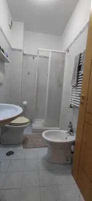 a bathroom with a shower and a toilet and a sink at l'altra casetta dei Quintili in Rome
