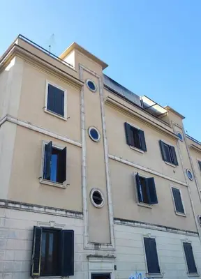 a large building with windows on the side of it at l'altra casetta dei Quintili in Rome