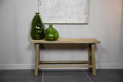 two green vases sitting on a wooden table at The Sanctuary Urban Retreat in Rome