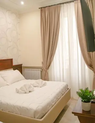 a bedroom with a white bed and a window at Esposizione Boutique in Rome