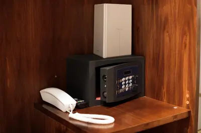 a phone and a fax machine on a wooden shelf at Esposizione Boutique in Rome