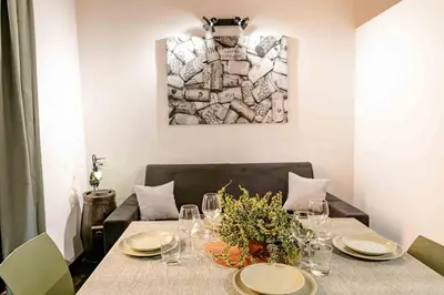a dining room table with plates and wine glasses at MyWay Colosseo Apartment in Rome