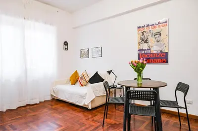 a living room with a couch and a table with chairs at St. Peter Vatican Home in Rome