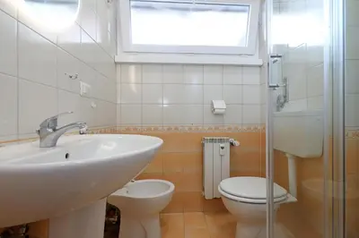a bathroom with a sink and a toilet and a window at Re di Roma - Charme Apartment in Rome