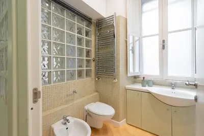 a bathroom with a toilet and a sink at VRhome in Rome