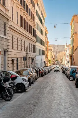 a city street with cars parked on the sides of the road at VRhome in Rome