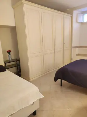 a bedroom with white cabinets and a bed at Home in Trastevere Testaccio in Rome