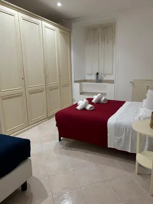 a bedroom with a red bed and a table at Home in Trastevere Testaccio in Rome