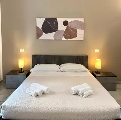 a bedroom with a large bed with towels on it at Bosuites Rome in Rome