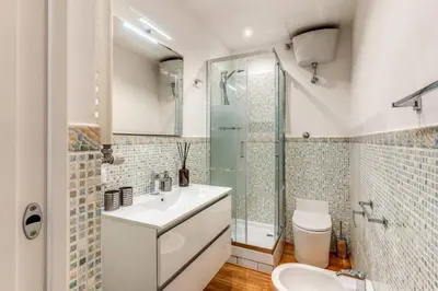 a bathroom with a sink and a shower and a toilet at Charming flat by the Vatican in Rome