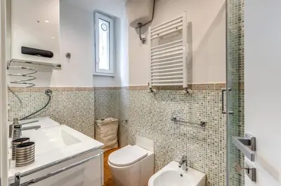 a bathroom with a toilet and a sink at Charming flat by the Vatican in Rome