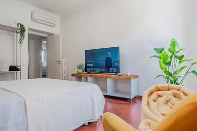 a bedroom with a bed and a flat screen tv at Alloggio Re di Roma 43 in Rome