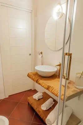 a bathroom with a bowl sink and a mirror at Alloggio Re di Roma 43 in Rome